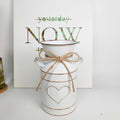 Distressed metal milk jug vase with jute rope wrap